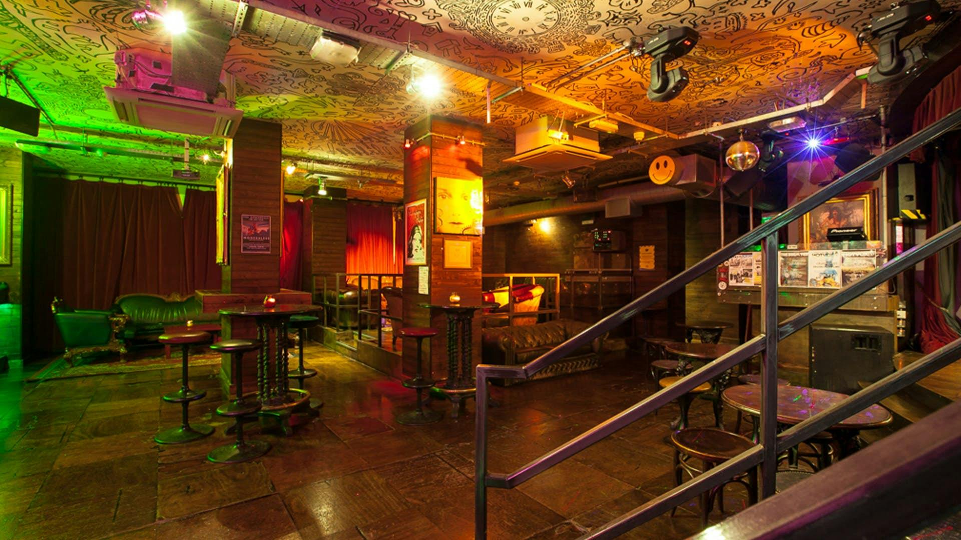 Hoxton Underbelly event space with colorful lighting, ideal for gatherings and performances.