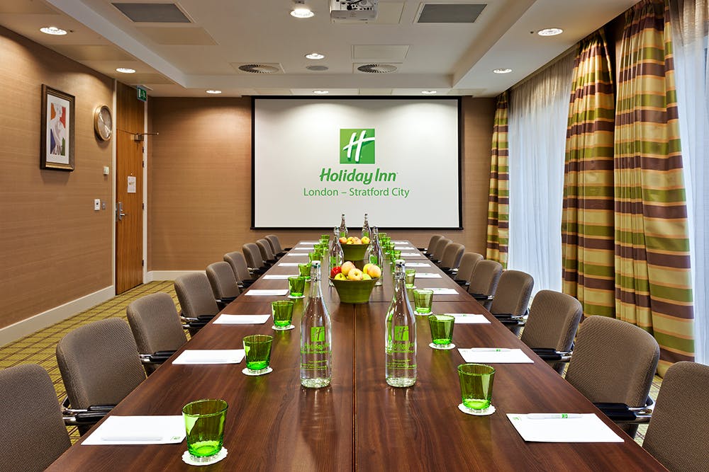 London Suite meeting room with wooden table, ideal for corporate events and workshops.