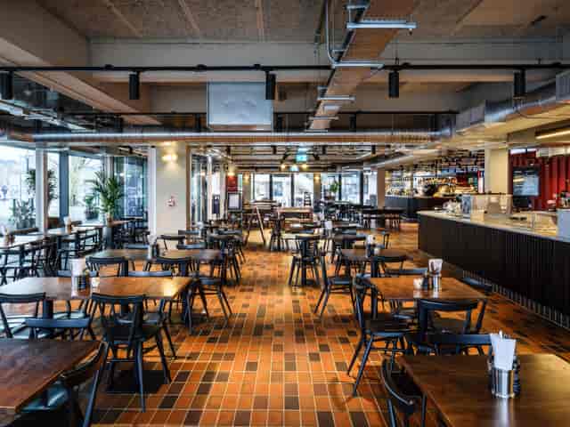 Riverfront and Balcony Bar, modern dining area with natural light for events and meetings.