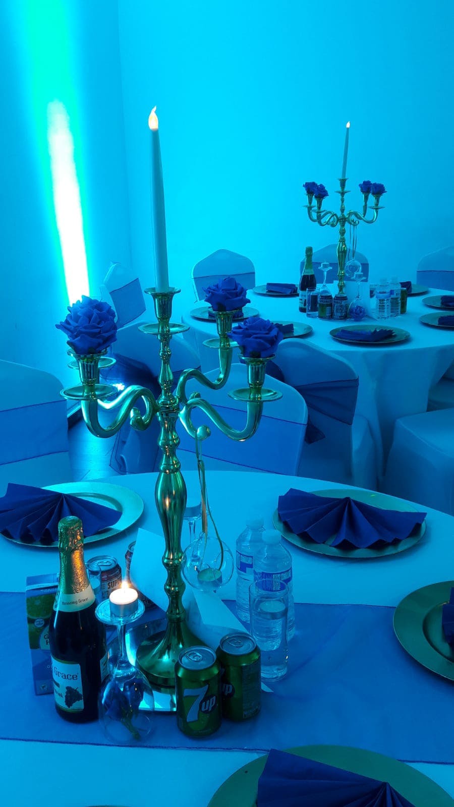 Elegant Mayfair Lounge event space with blue accents and gold candelabra for formal gatherings.