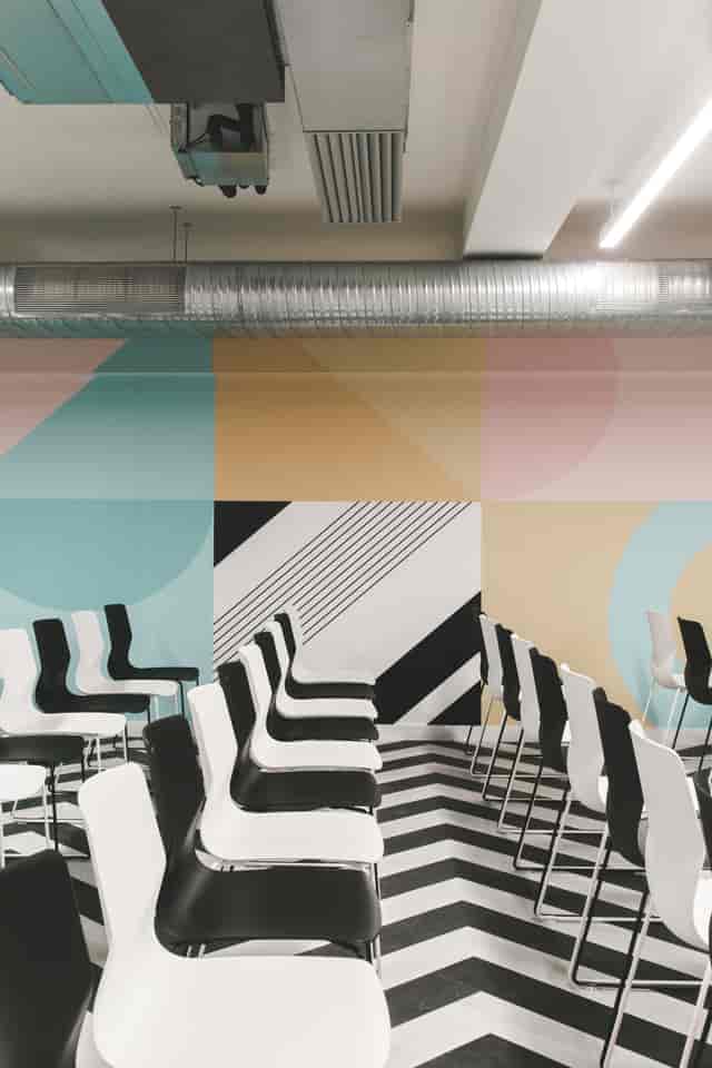 Modern breakout space at Live Lounge, Huckletree Ancoats with geometric wall for creative workshops.