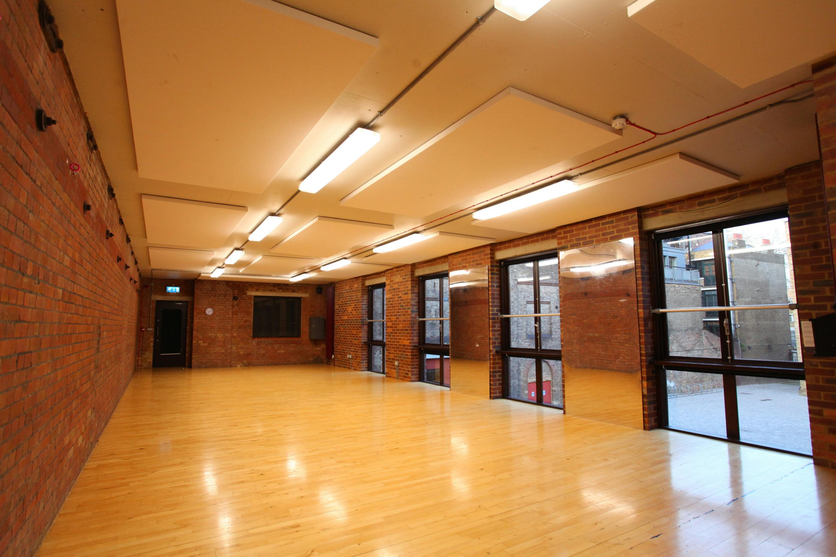 Versatile event space in Shoreditch with exposed brick and natural light for gatherings.