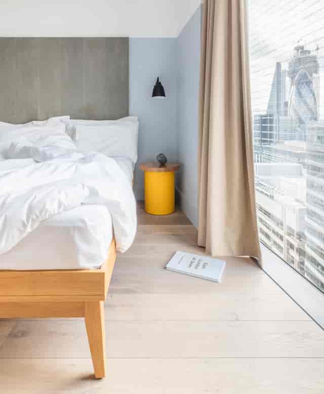 Modern hotel room with city view, ideal for meetings and events.