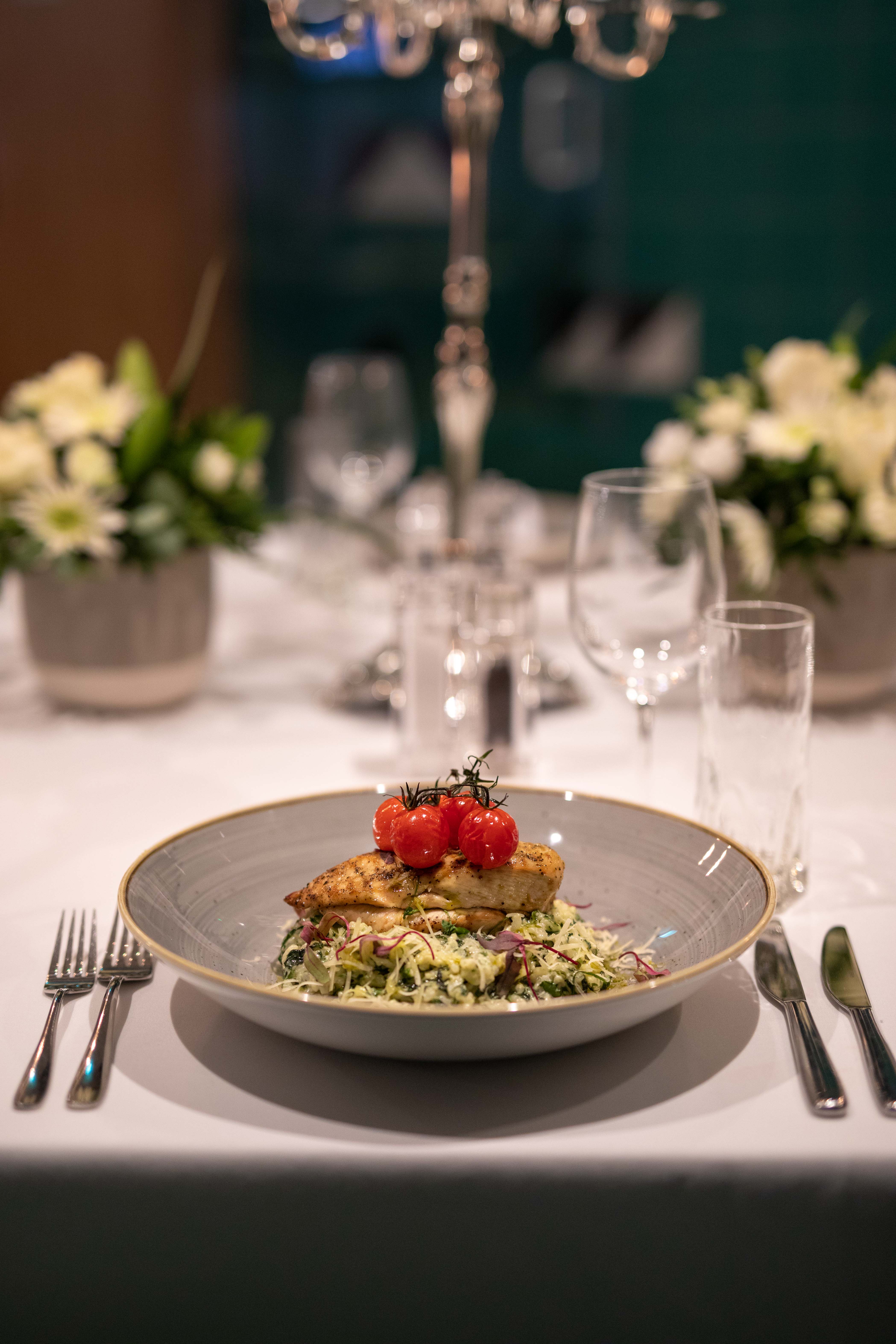 Grilled chicken dish in elegant Green Room, ideal for corporate events and upscale dining.