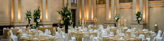 Elegant banquet hall with gold tablecloths, perfect for weddings and corporate events.
