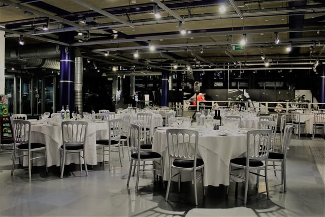 Elegant dinner setup at Past Gallery, featuring round tables and sophisticated ambiance.