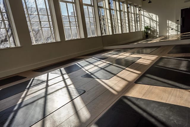 Spacious wellness studio with yoga mats, perfect for mindfulness events and retreats.