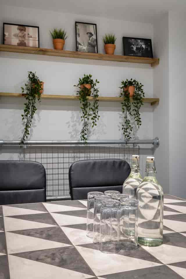 Modern meeting room with sleek black chairs and greenery for productive discussions.