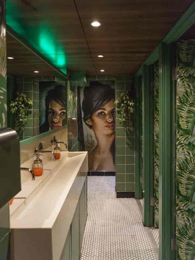 Creative restroom with vibrant greenery at Trailer Happiness event venue.