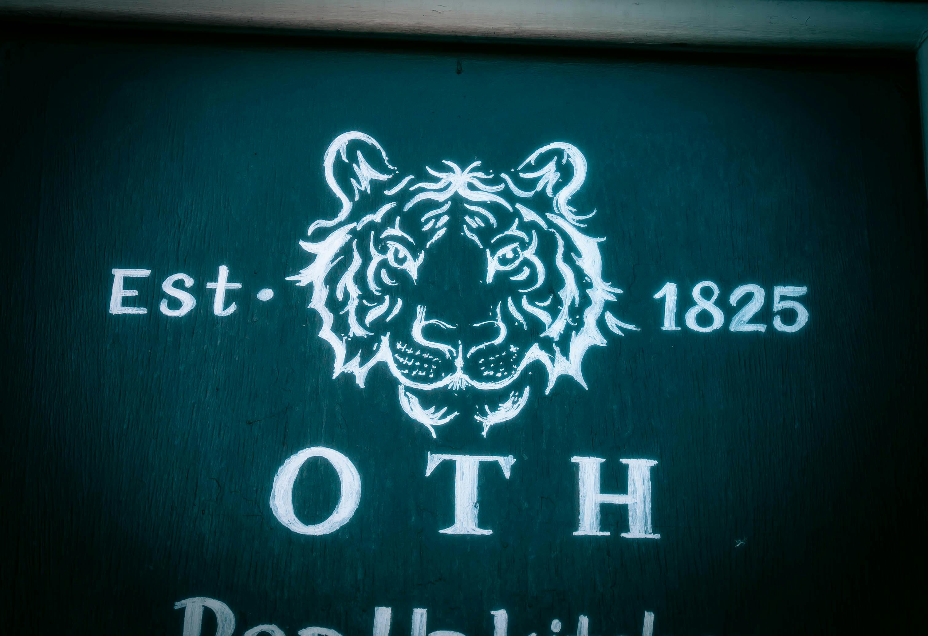 Vintage tiger head sign at Tigers Lounge, ideal for corporate events and gatherings.