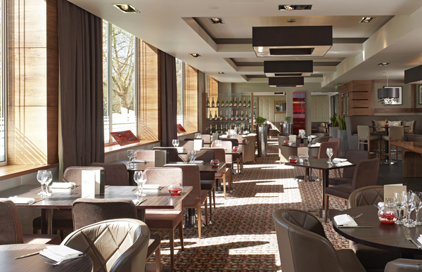 Modern restaurant with large windows, ideal for intimate meetings and events. - Banner