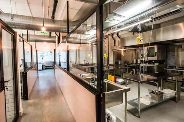 Industrial-chic kitchen co-working space for culinary workshops and team-building events.