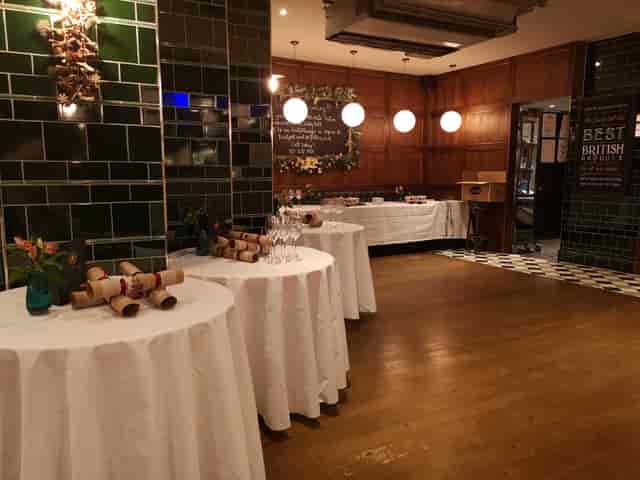 Elegant event space at The Trinity Bell with draped tables for networking and celebrations.