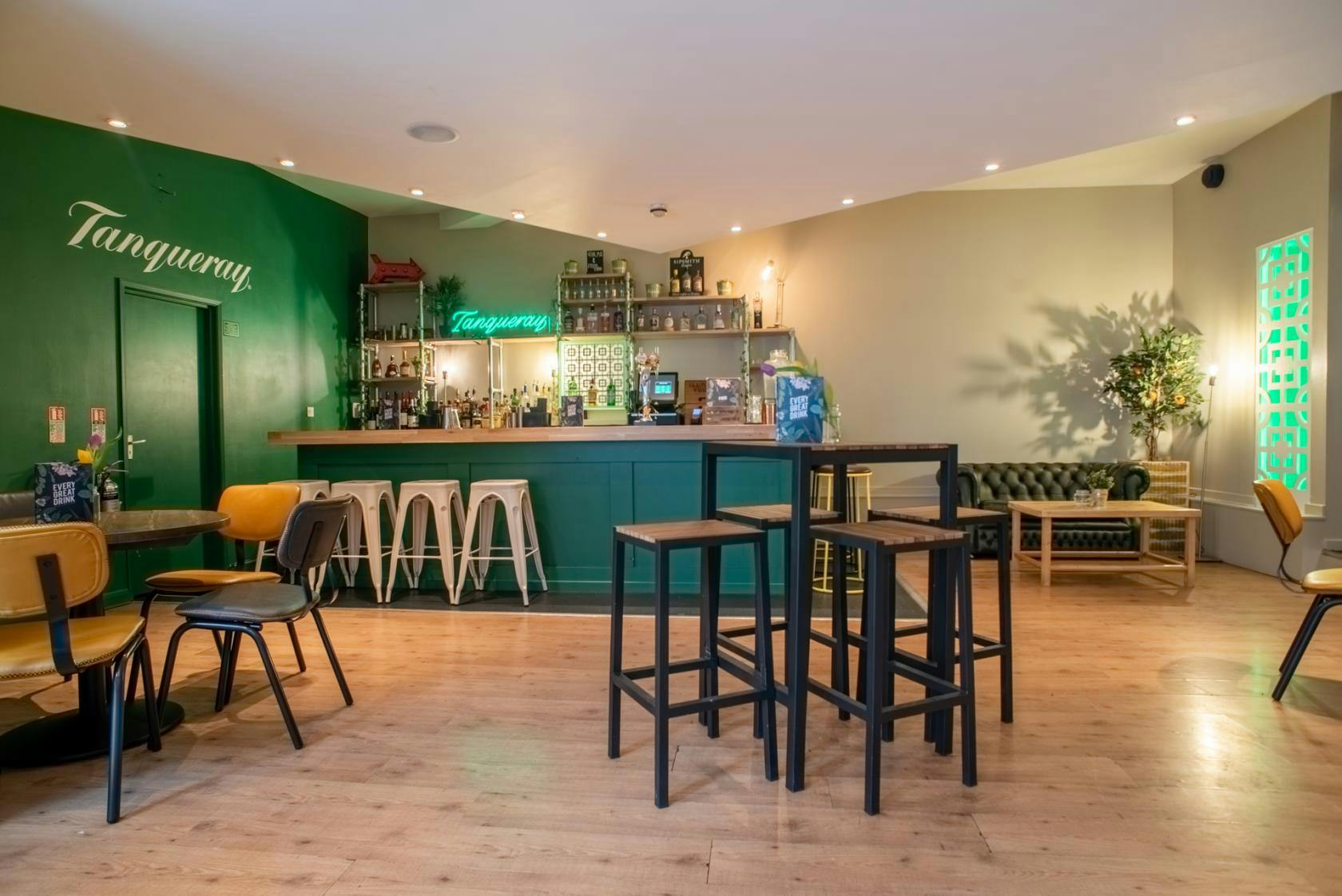 Stylish bar area with vibrant green accents, perfect for networking events and cocktail receptions.