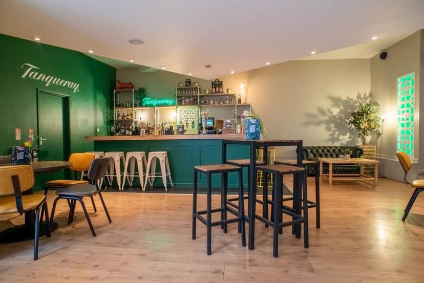 Stylish bar area with vibrant green accents, perfect for networking events and cocktail receptions.