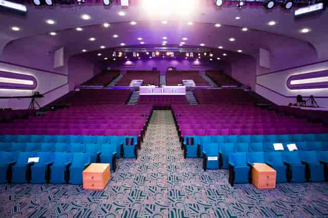 Auditorium in Gateway House with teal and purple seating, ideal for conferences and performances.