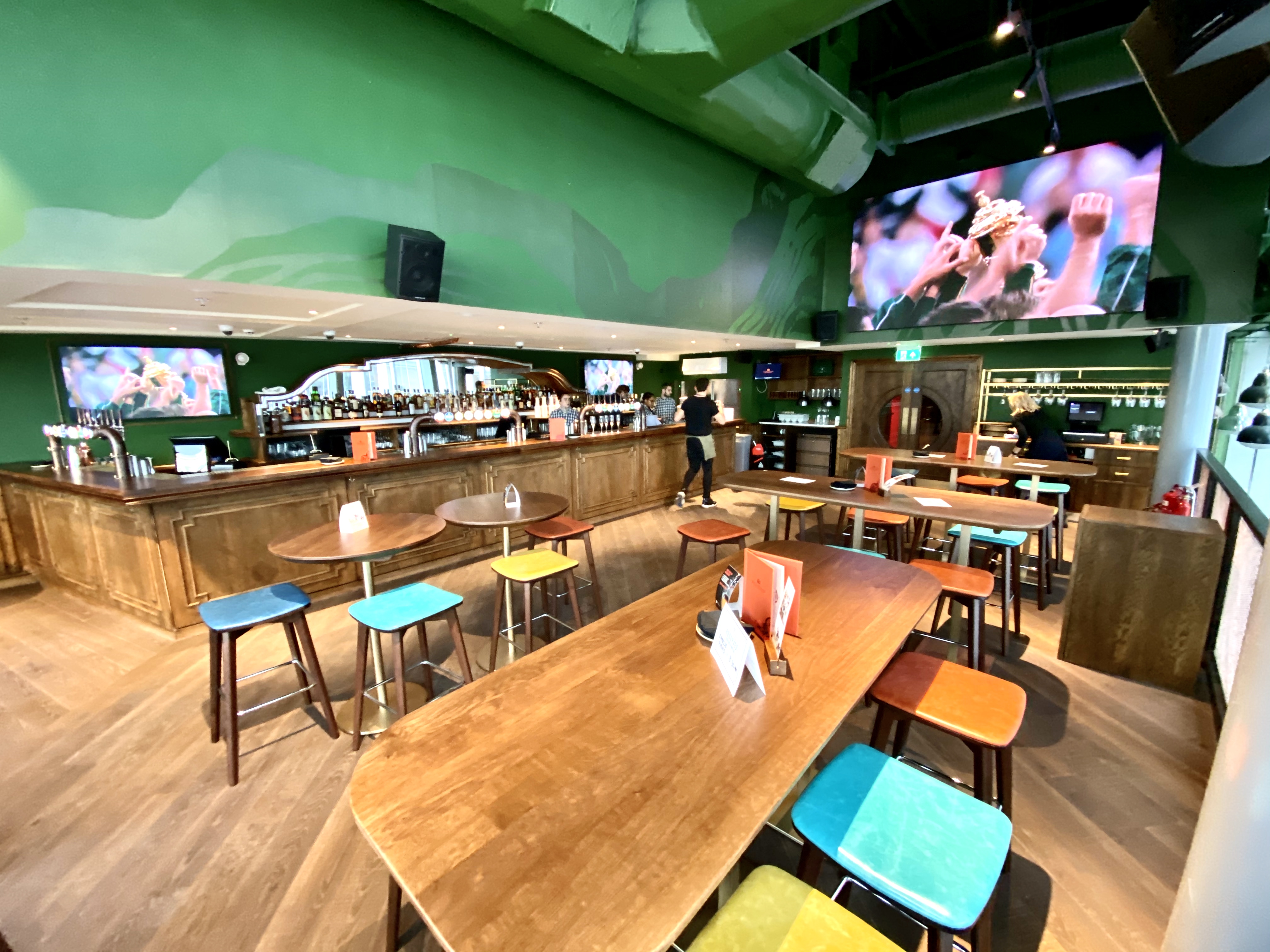 Vibrant Sports Lounge with modern bar, ideal for casual gatherings and events. - Banner