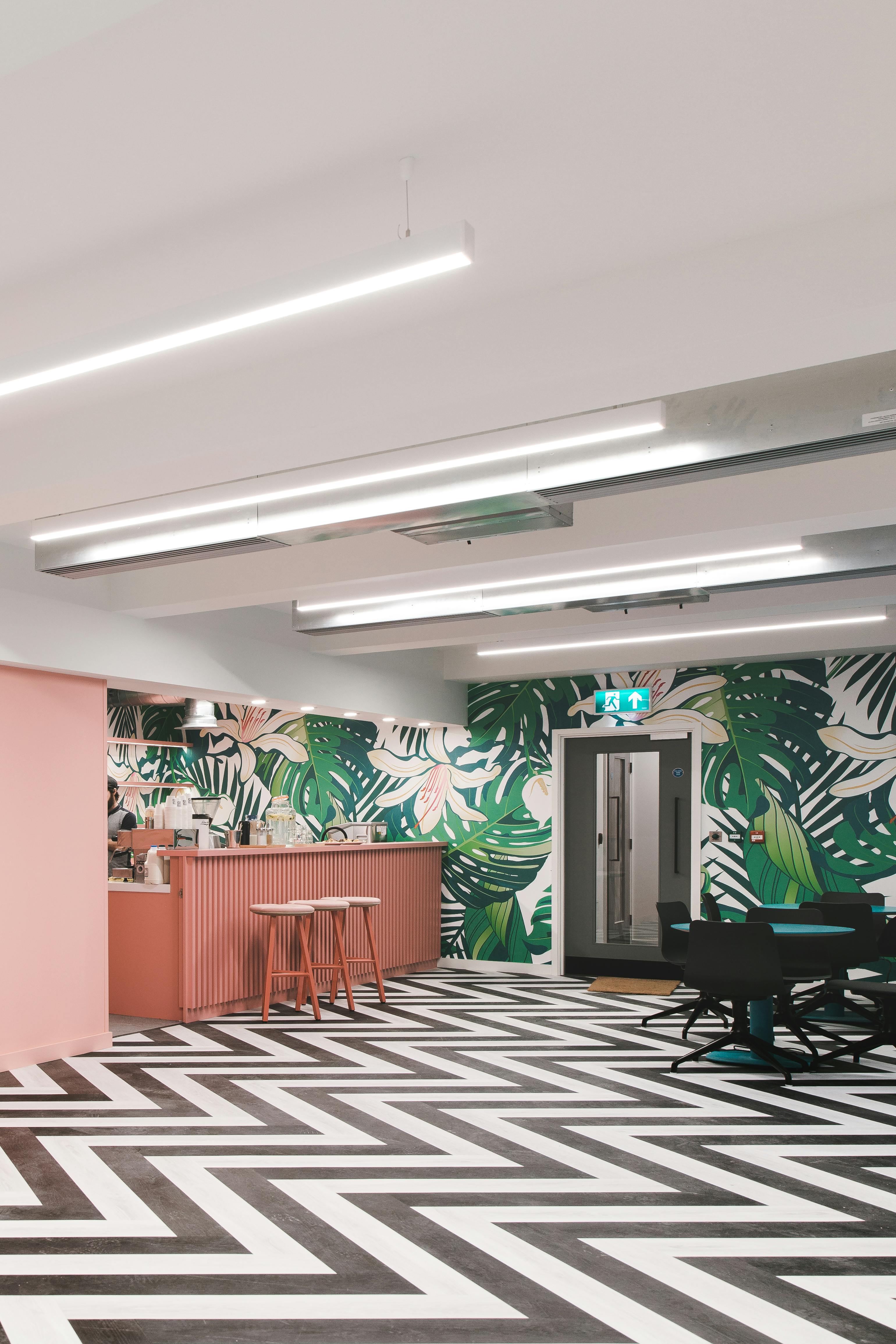 Vibrant meeting space with tropical mural for team-building and networking events.