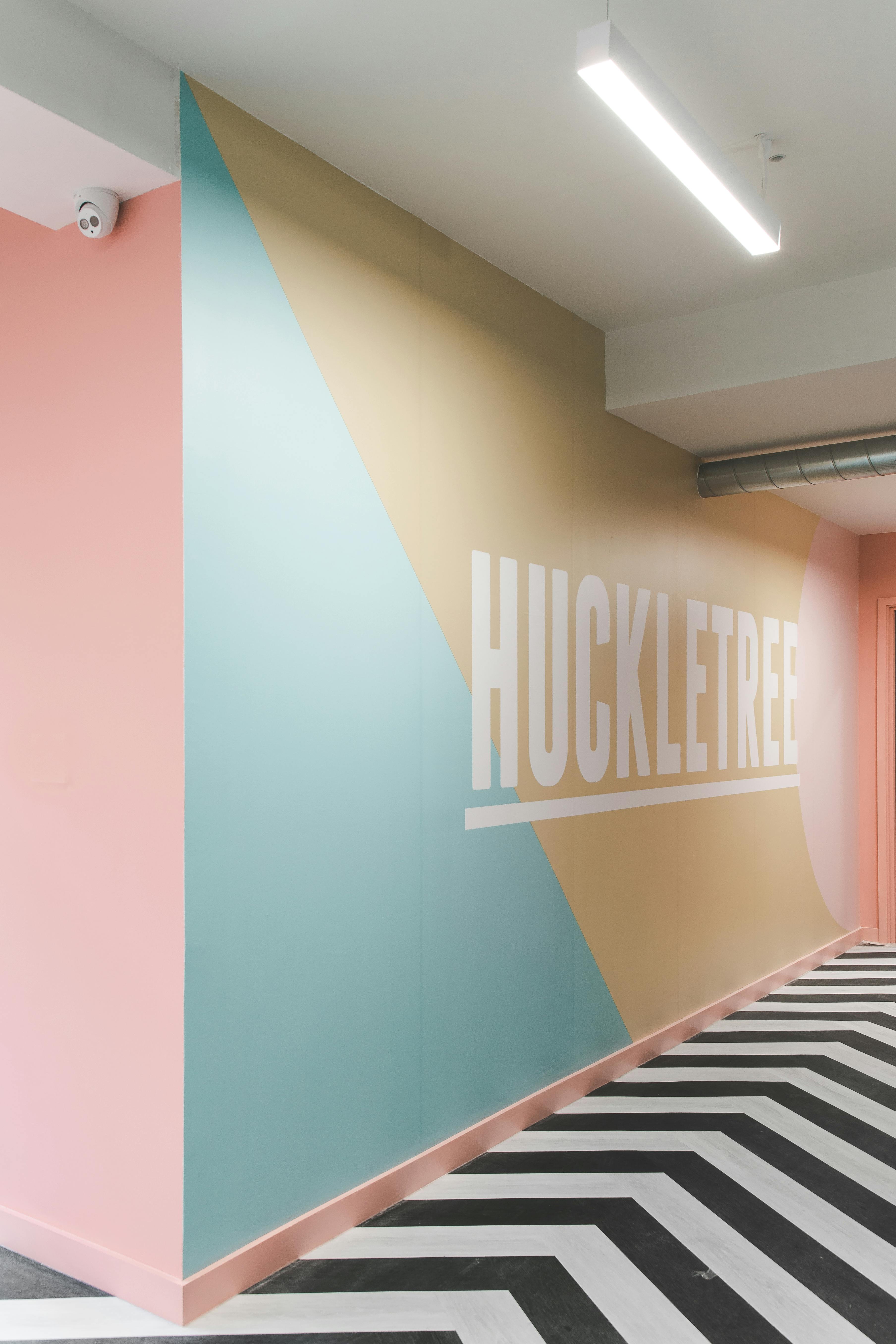 Vibrant Huckletree wall design in pastel colors for creative meetings and events.