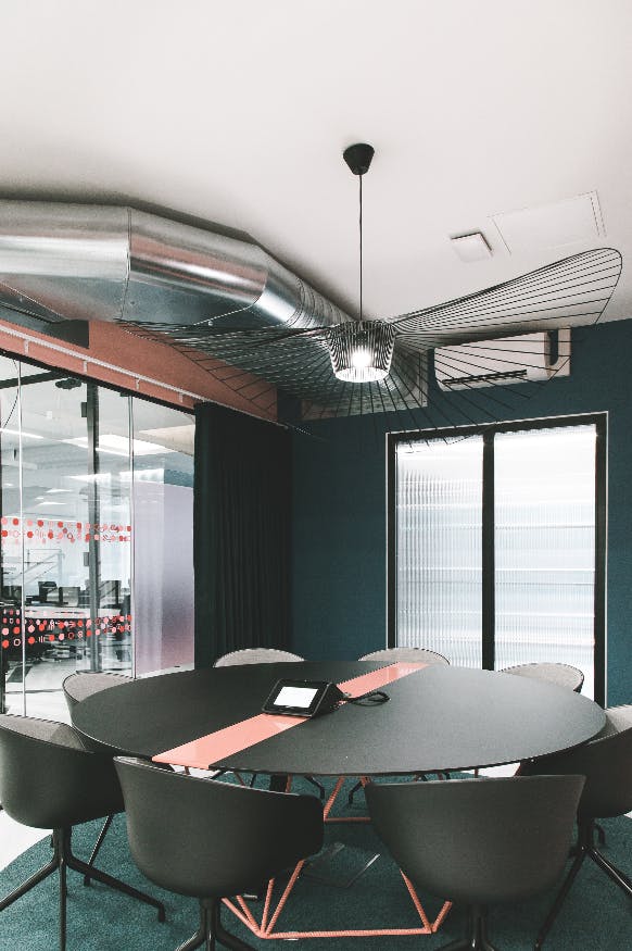 Modern meeting room in Huckletree Ancoats, featuring sleek furnishings and natural light.