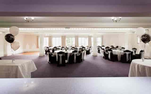 Elegant event space at Burton Ritz with round tables, perfect for celebrations and gatherings.