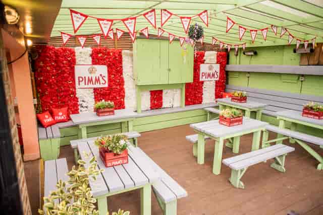 Roof Terrace at Abbey Tavern with floral backdrop, ideal for summer parties and gatherings.