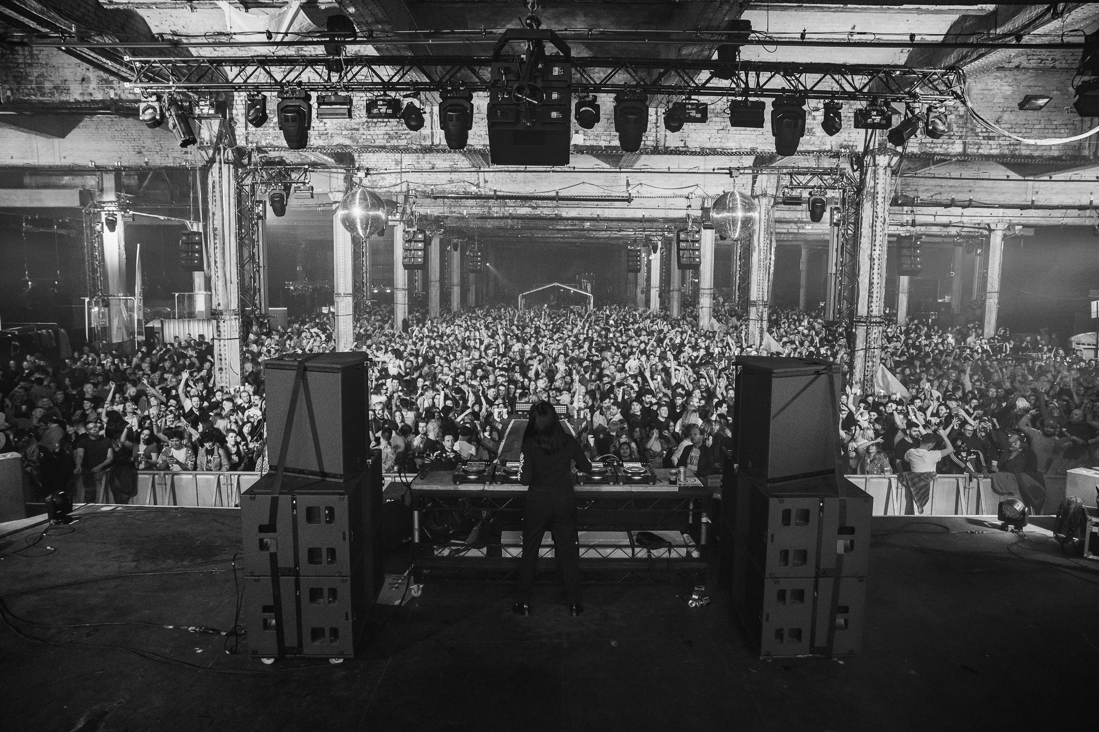 Crowd at Depot Mayfield venue with DJ, showcasing immersive event atmosphere.