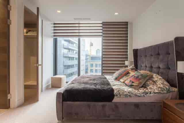 Modern penthouse venue with plush bed for intimate events and filming sessions.