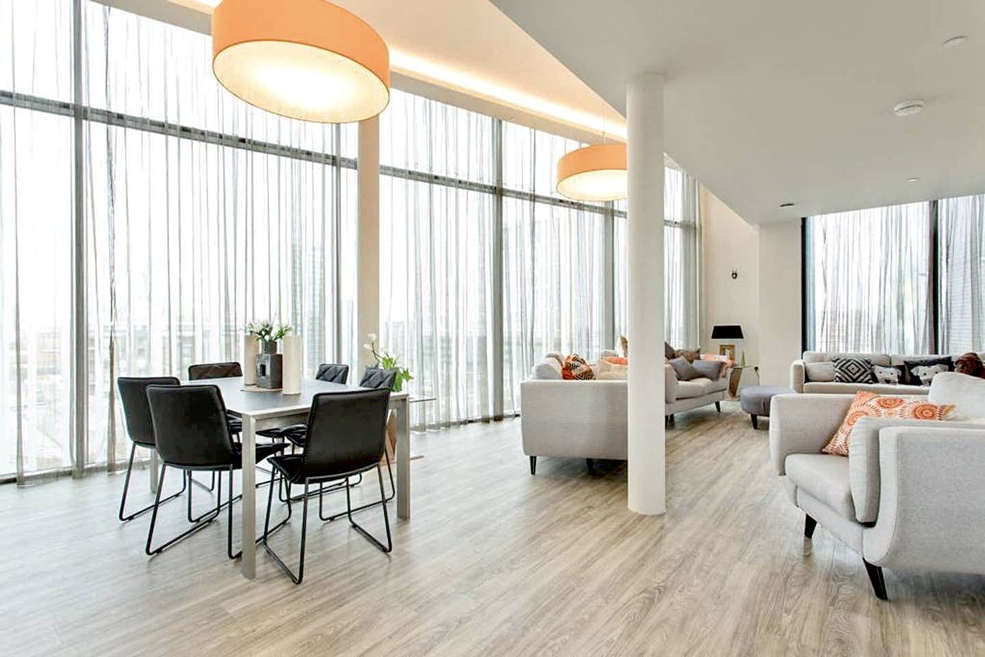 Modern penthouse event space with large windows for filming and gatherings.