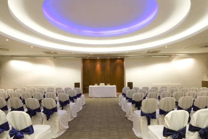 Apex Suite event space with blue-sashed chairs, ideal for conferences and gatherings.