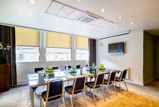 Modern meeting room in Apex Grassmarket Hotel, featuring a sleek glass table for conferences.