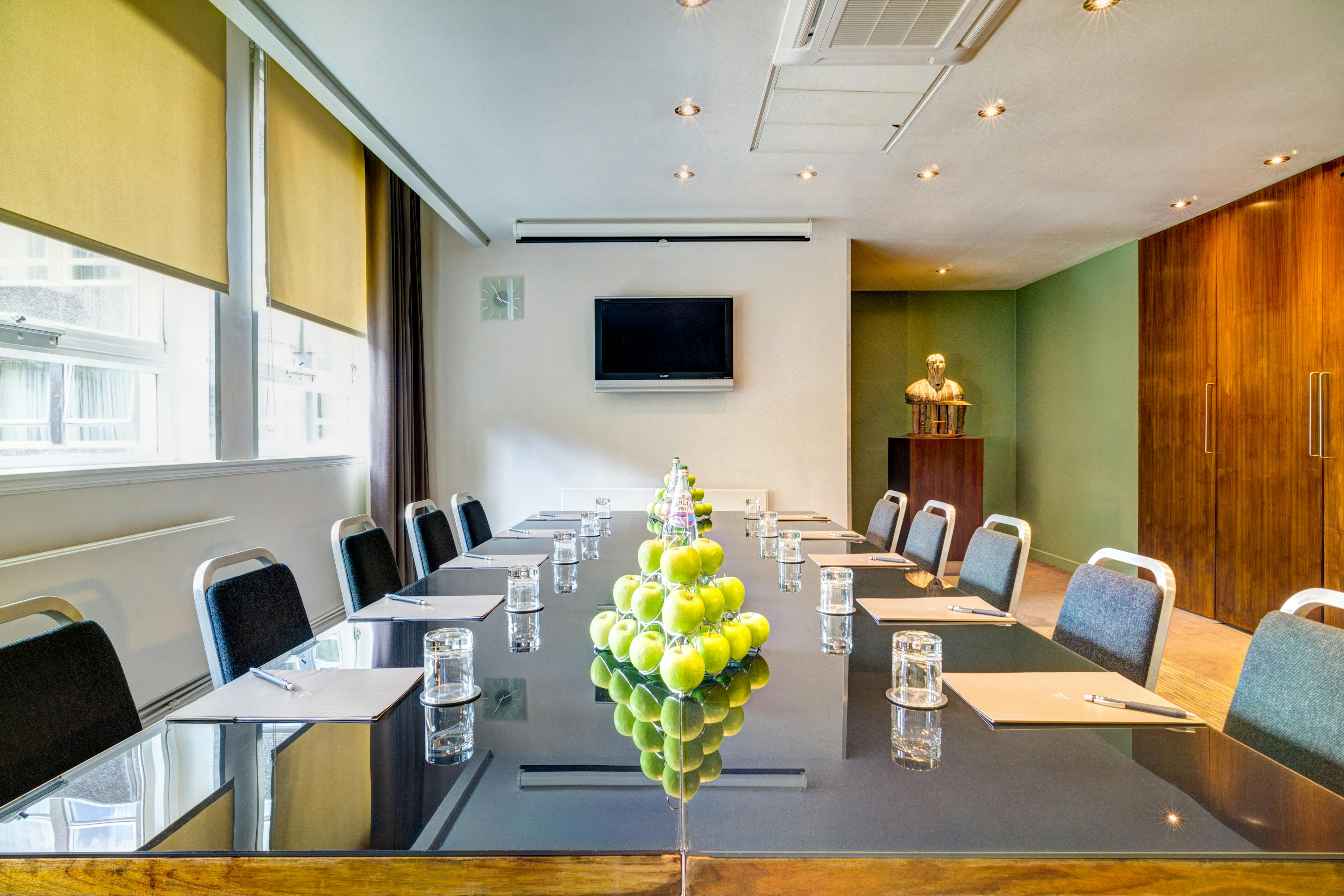 Modern meeting room with glass table, ideal for professional events in Apex Grassmarket Hotel.