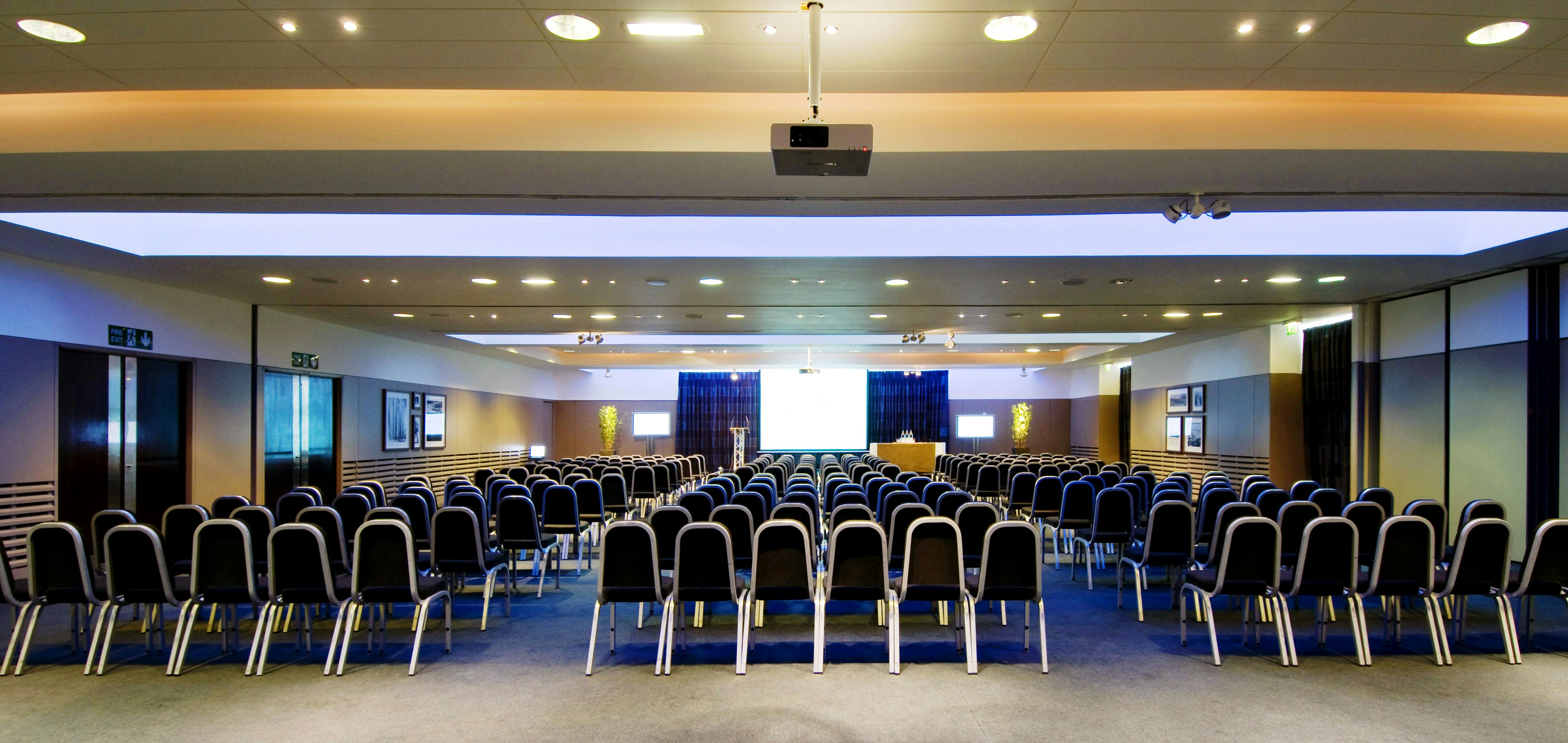 City Quay Suite conference room with black chairs, ideal for meetings and presentations.