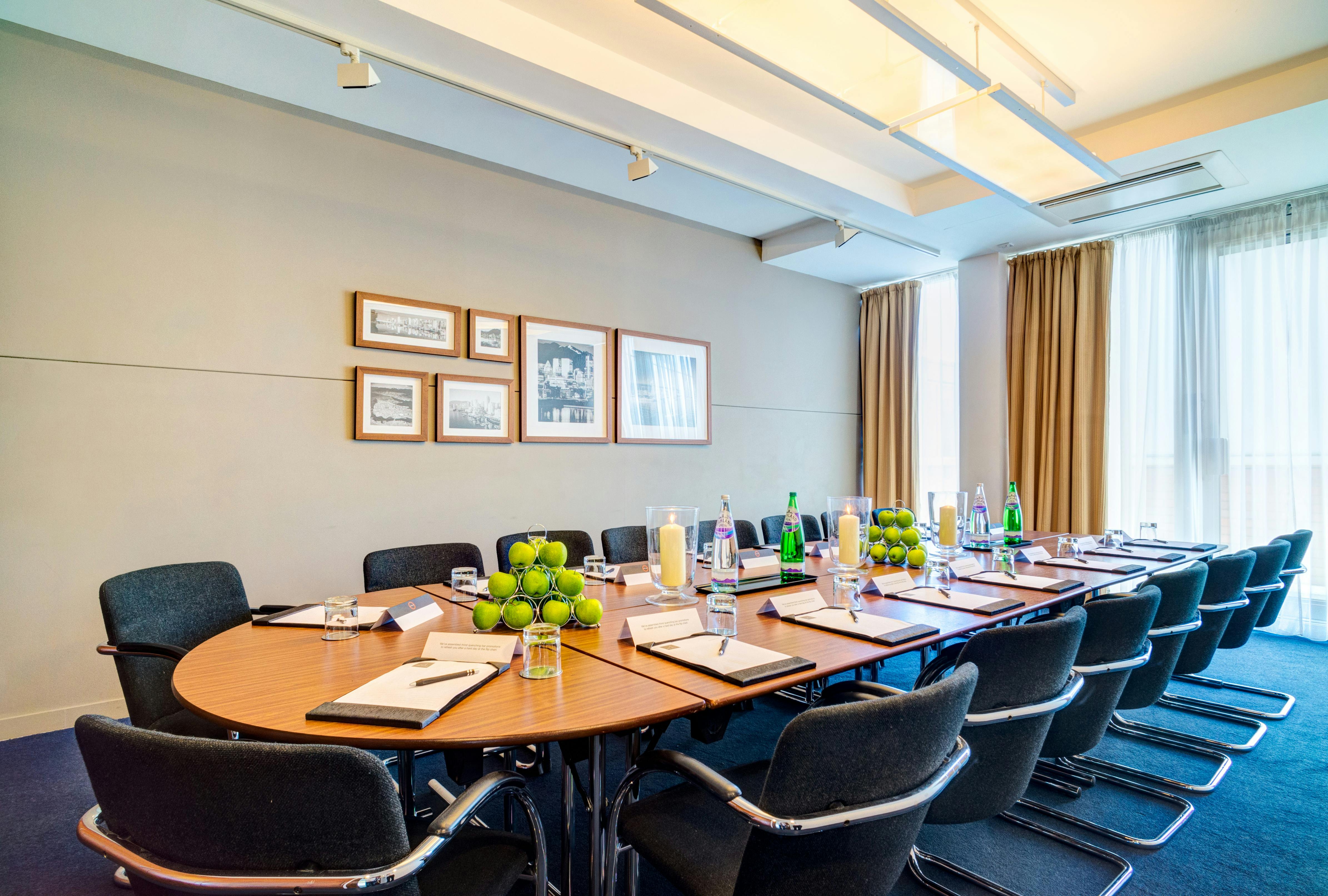 "Elegant meeting room with round table for corporate events in Apex City Quay Hotel."