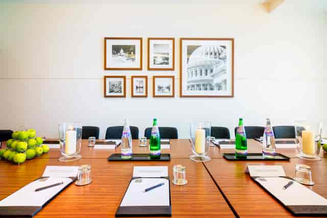 "Professional meeting room setup with notepads and tennis balls in Apex City Quay Hotel."