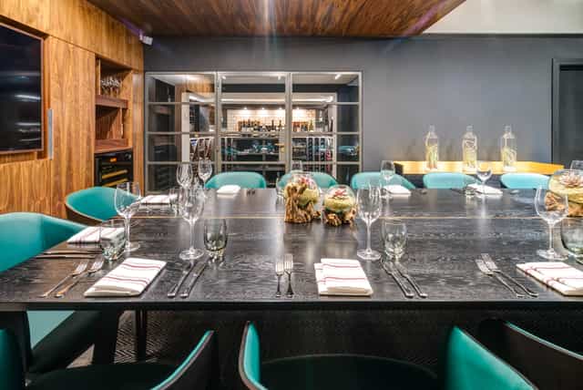Sophisticated meeting space with dark wood table at Apex Temple Court Hotel.