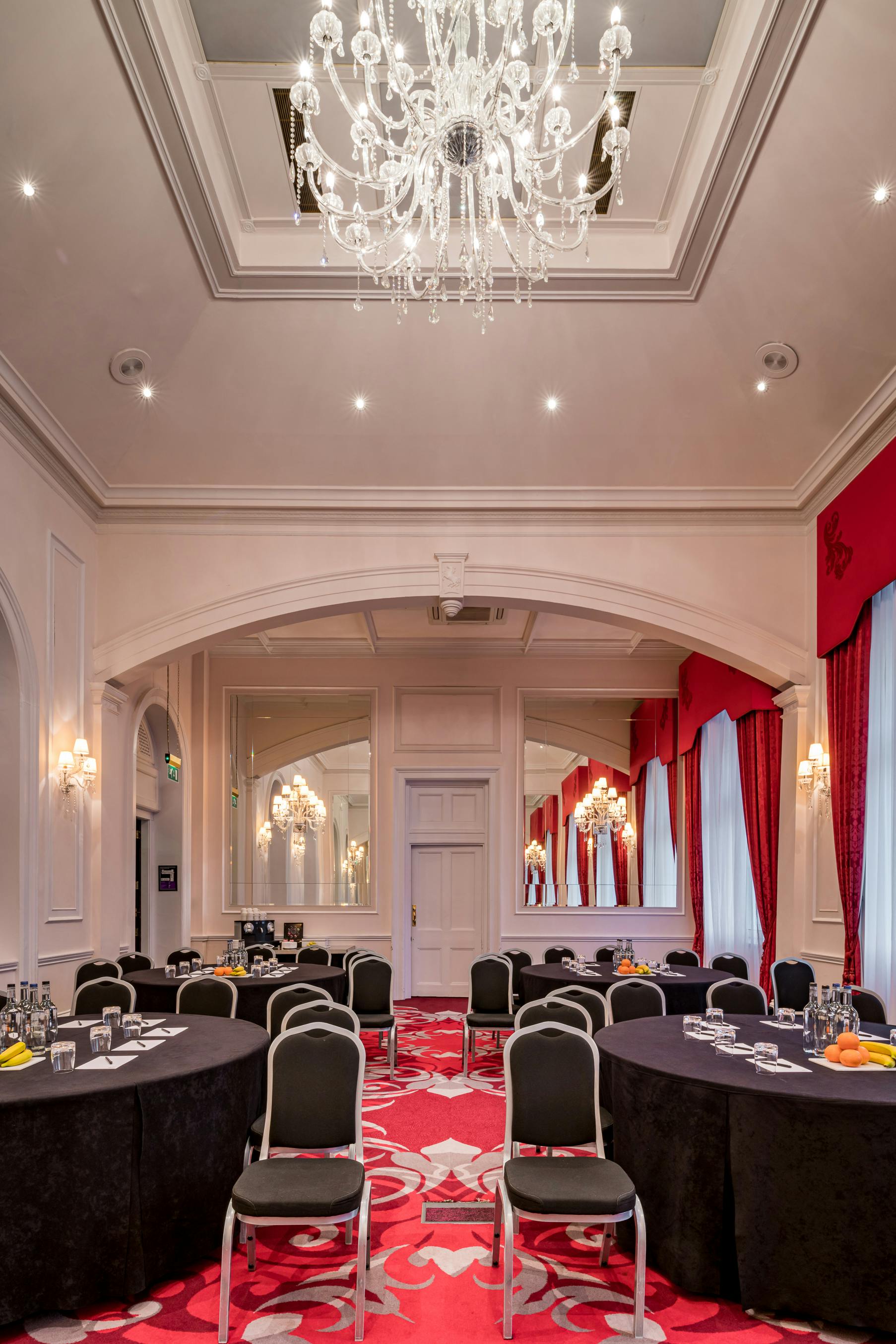 Elegant event space at The Clermont Charing Cross with chandeliers, ideal for corporate meetings.
