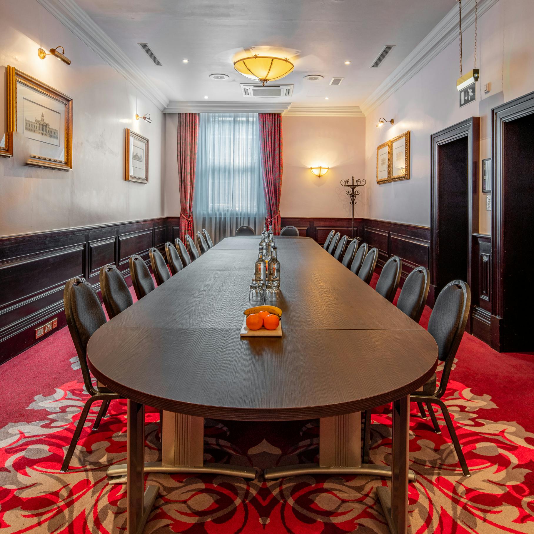 Boardroom at The Clermont Charing Cross with elegant table, ideal for meetings and events.