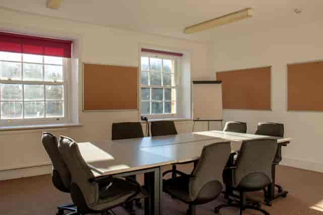 Richard Hawkins in a bright, collaborative meeting room with ergonomic chairs for workshops.