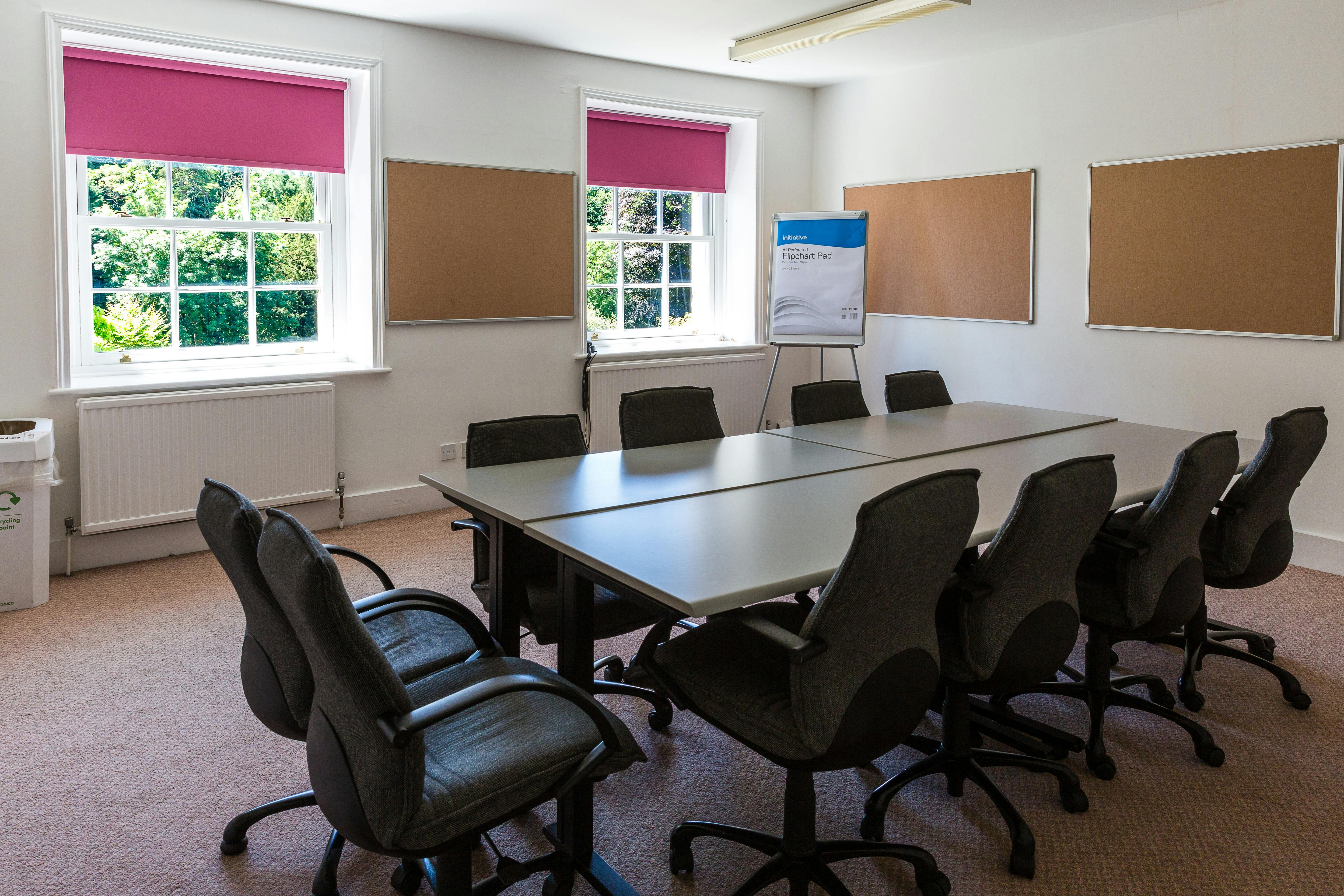 Richard Hawkins in a bright meeting room with a large table, ideal for workshops and discussions.