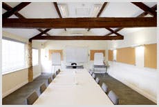 Bright meeting room at Brympton, featuring a long table for collaborative workshops.