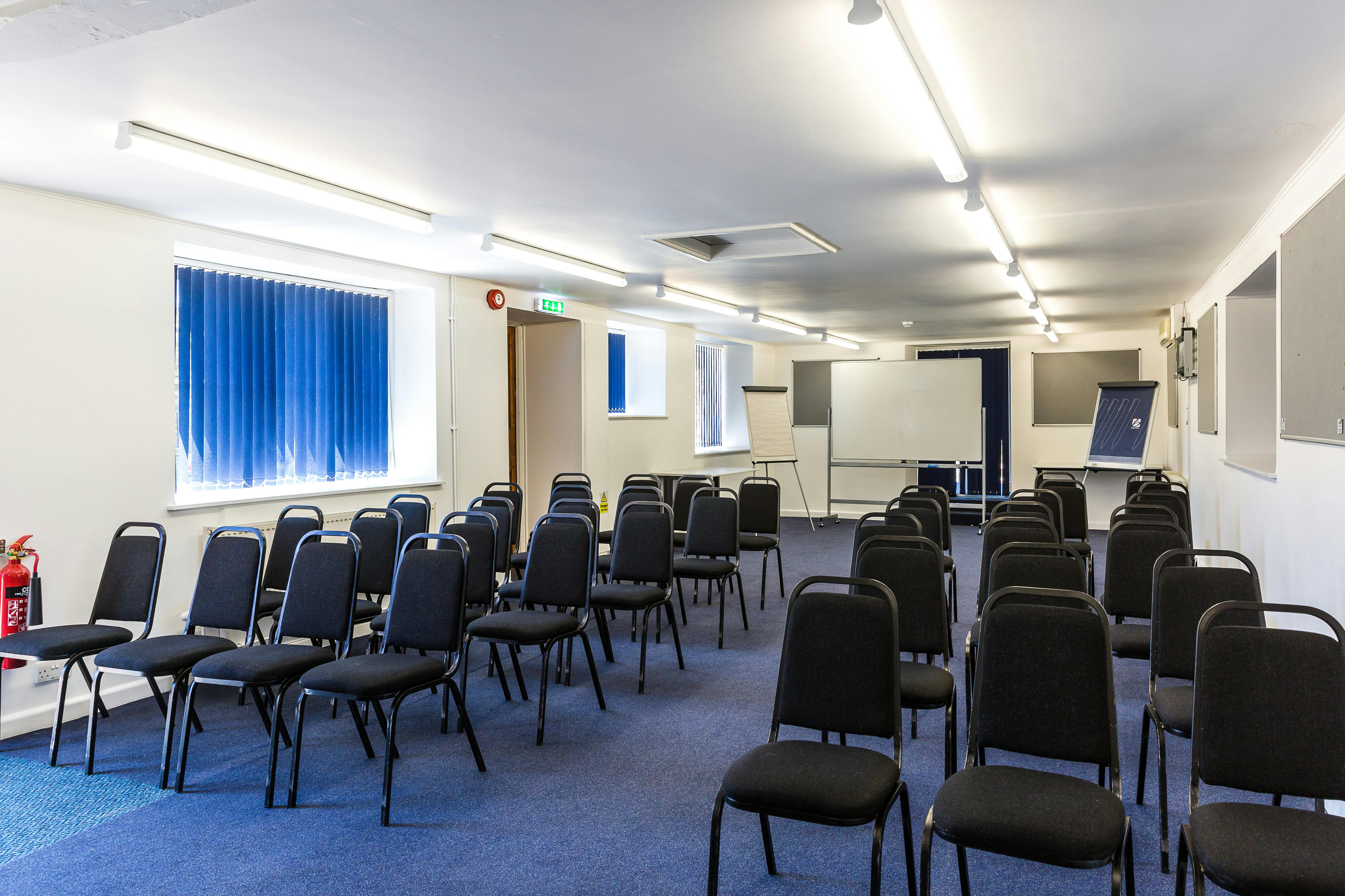 William Kent meeting space with black chairs, ideal for workshops and presentations.