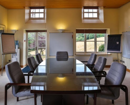 Oak Room at Middle Aston House: bright meeting space with glass table for workshops.