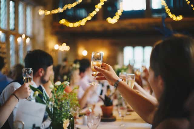 Elegant event setting with guests toasting, perfect for weddings and celebrations.