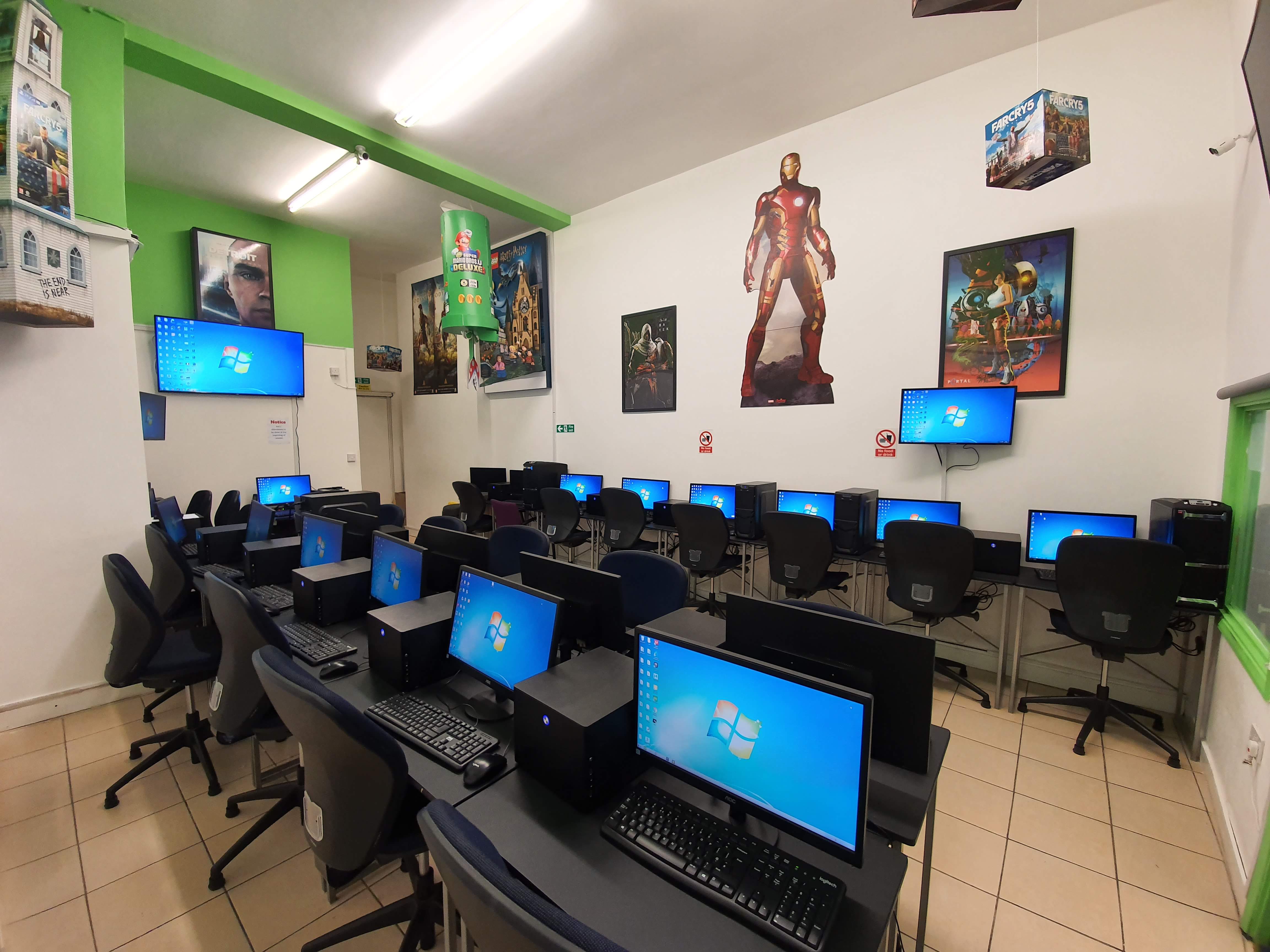 Tech-equipped training room with computer stations for workshops and seminars. - Banner