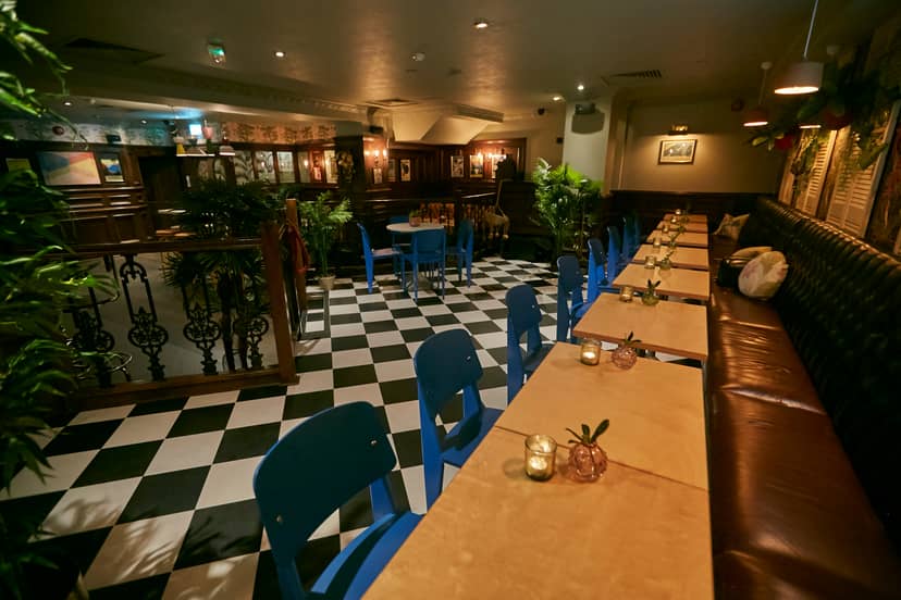Stylish bar and restaurant event space with checkered floor, ideal for networking and dinners.