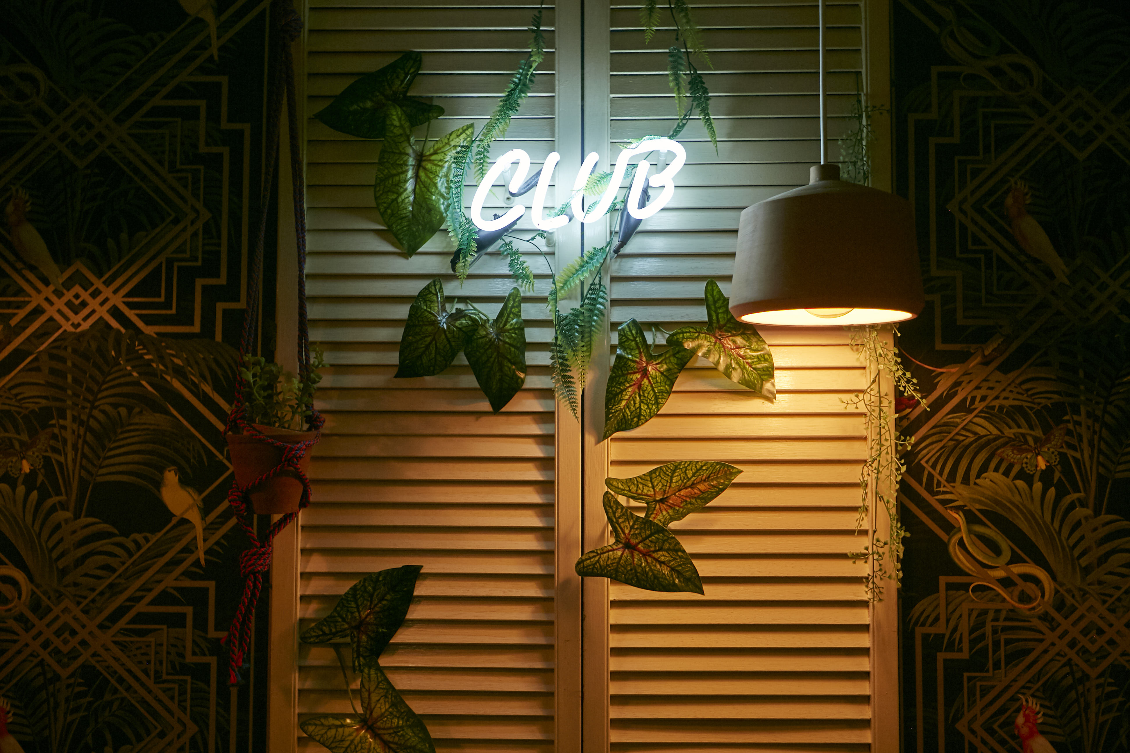 Stylish bar with neon "CLUB" sign, perfect for social gatherings and themed parties. - Banner