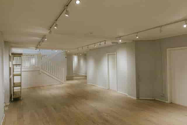 Versatile event space at 725 Fulham Road with wooden flooring, ideal for workshops.