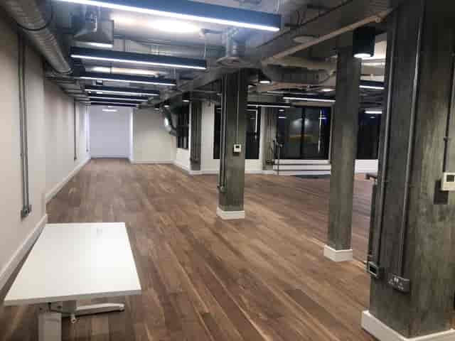 Versatile event space with polished wood floors, ideal for workshops and corporate meetings.