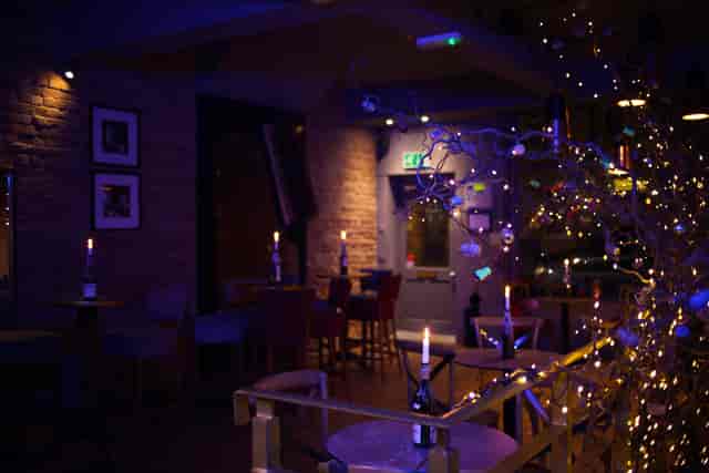 Cozy event space at Sandy's Piano Bar with soft lighting for holiday parties.